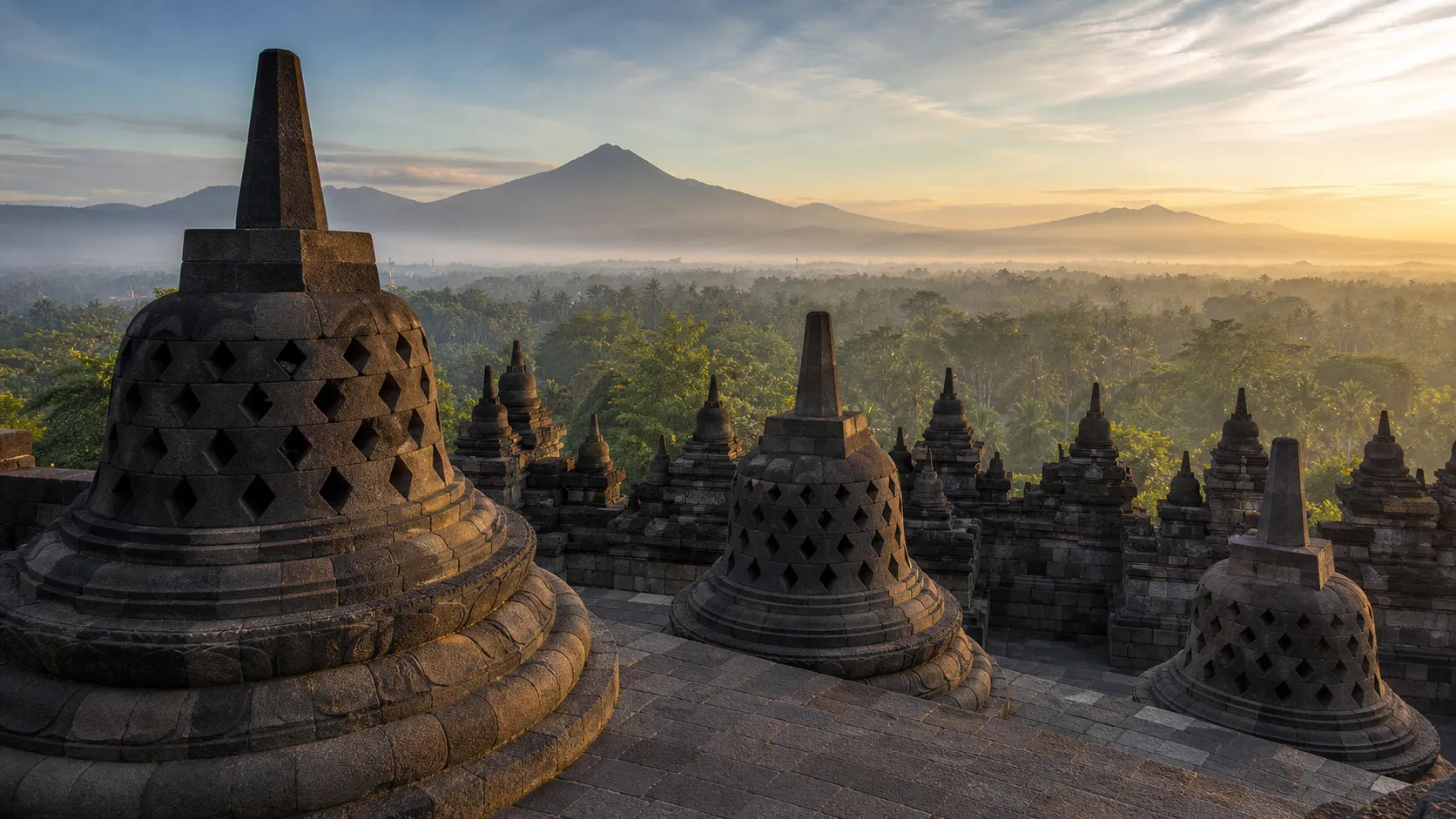 Borobudur temple at sunrise with Central Java's mountains beyond