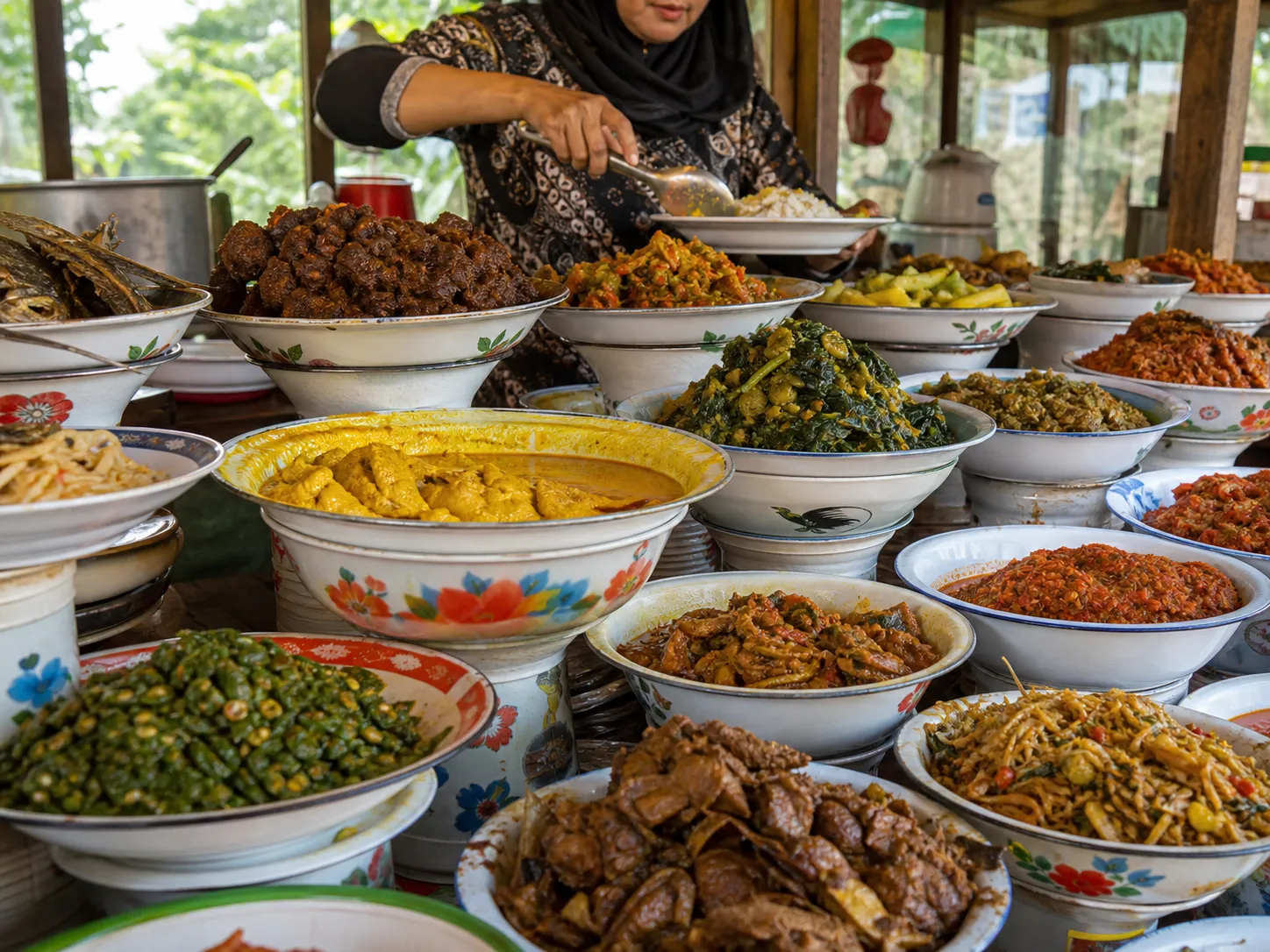 A Nasi Kapau vendor serving rice behind a raised display of Minangkabau dishes